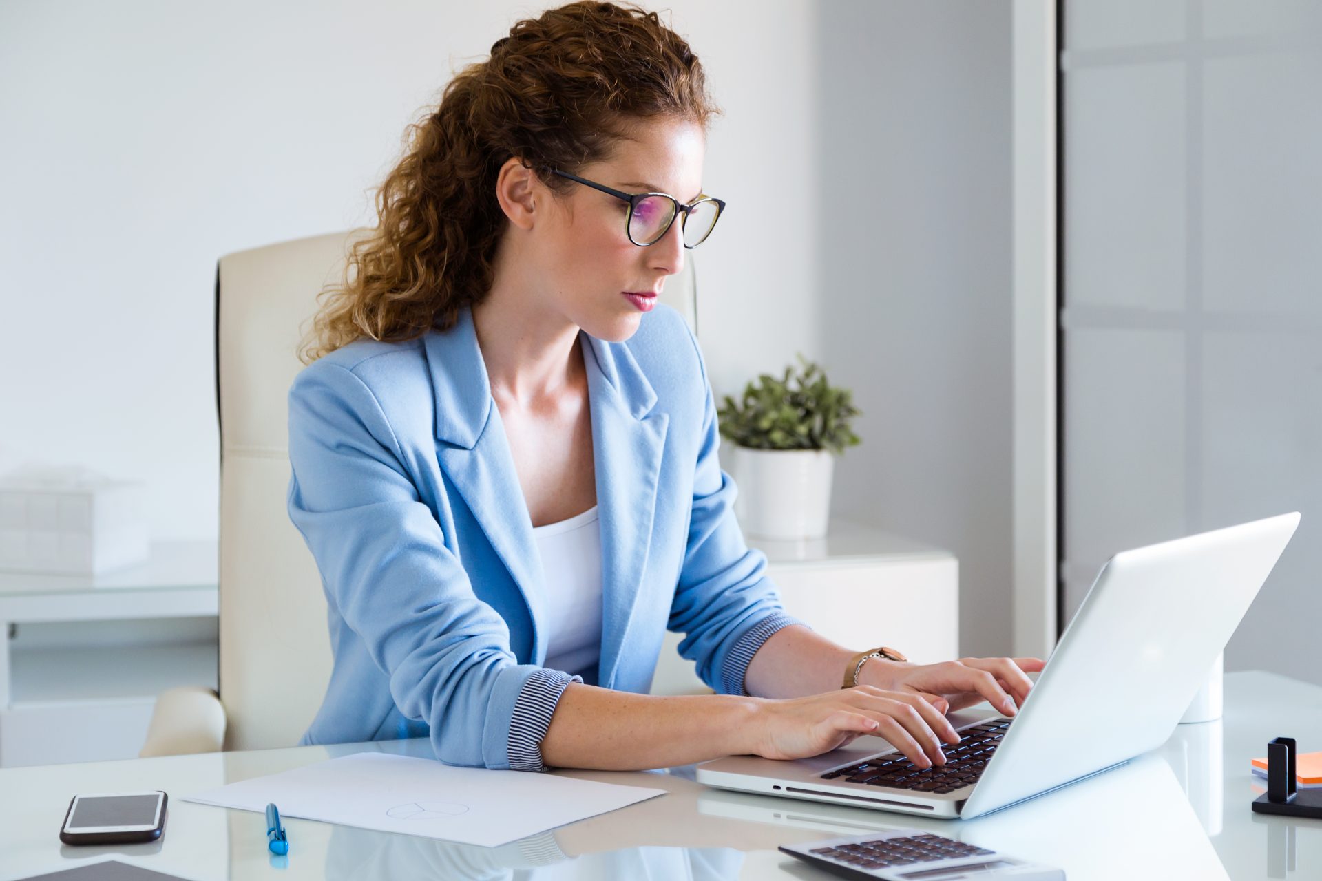 beautiful-businesswoman-working-with-her-laptop-office