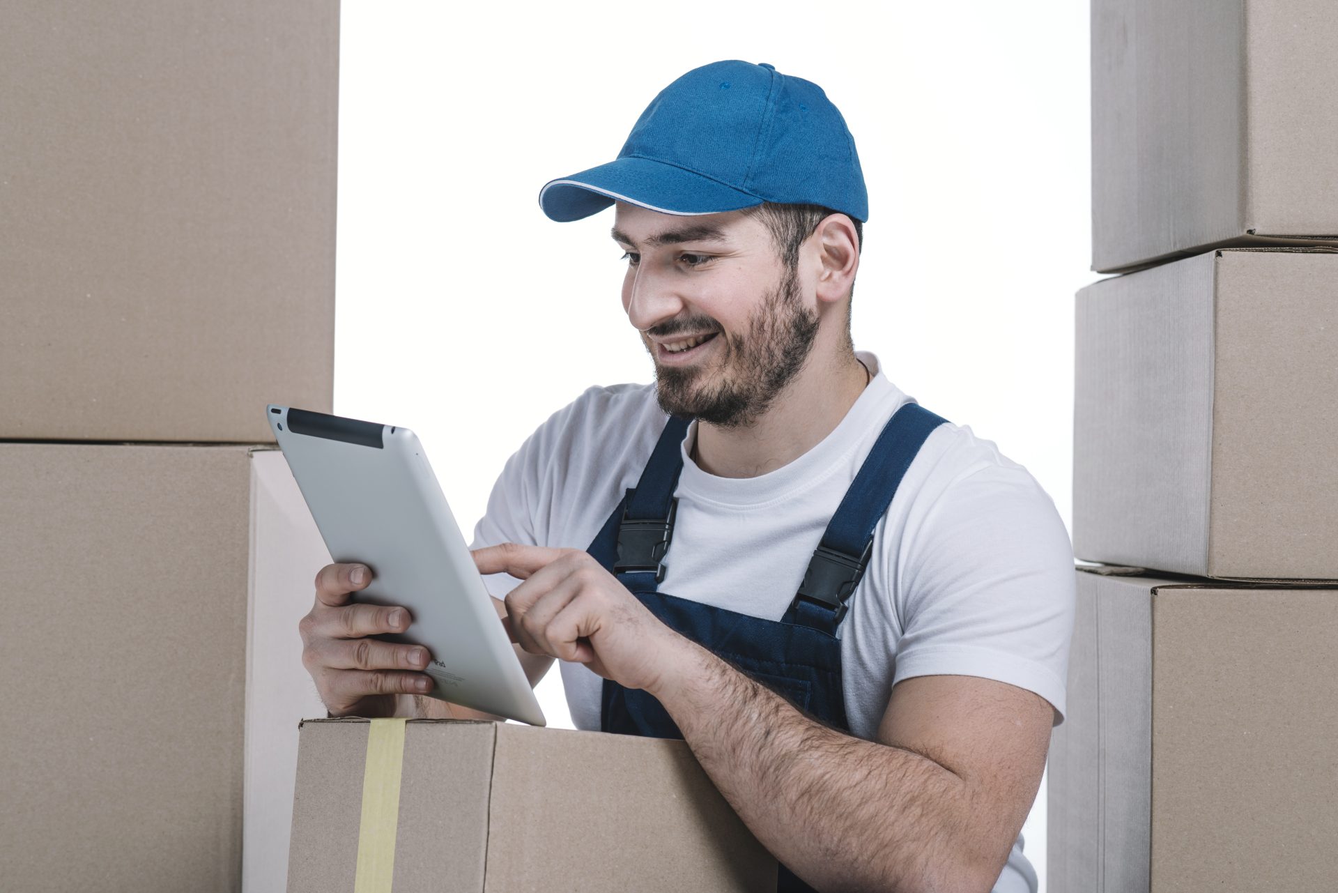 cheerful-deliveryman-using-tablet